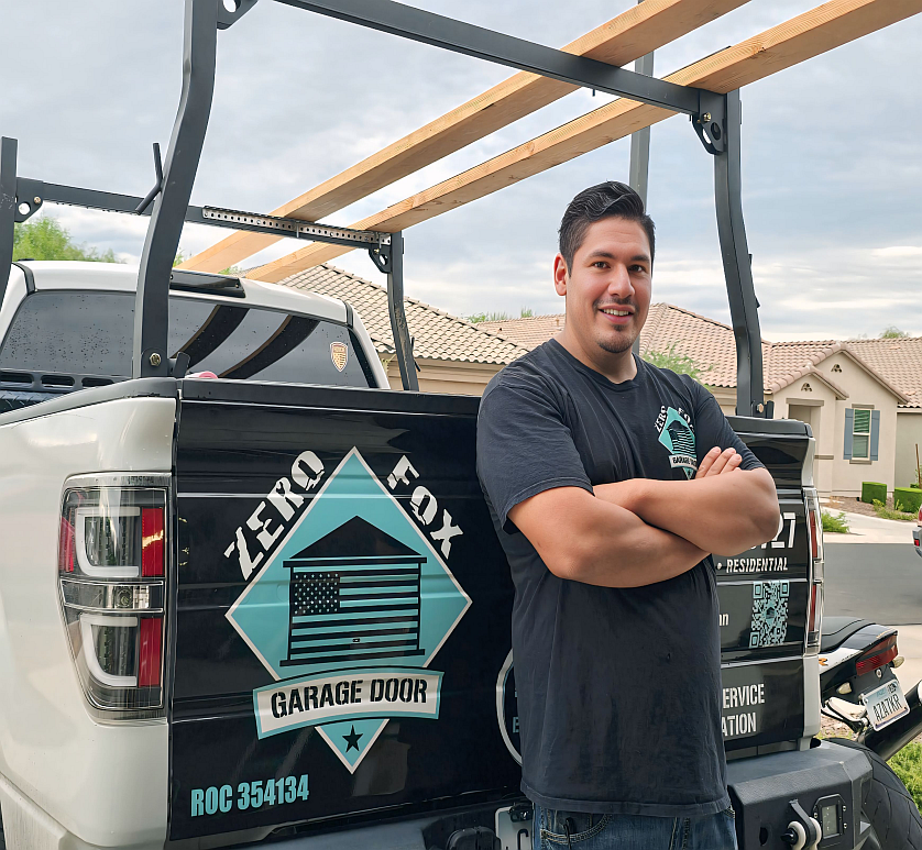 Emilio from Zero Fox Garage Door beside his service truck